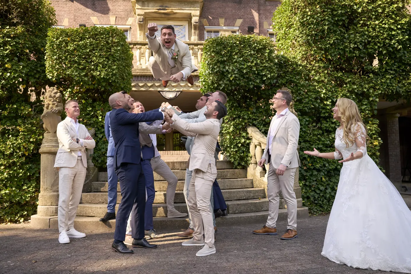 Bruidegom wordt door zijn vrienden de lucht in gegooid op Kasteel de Hooge Vuursche